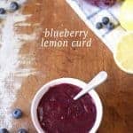 Homemade Blueberry Lemon Curd in a white bowl on a wooden board