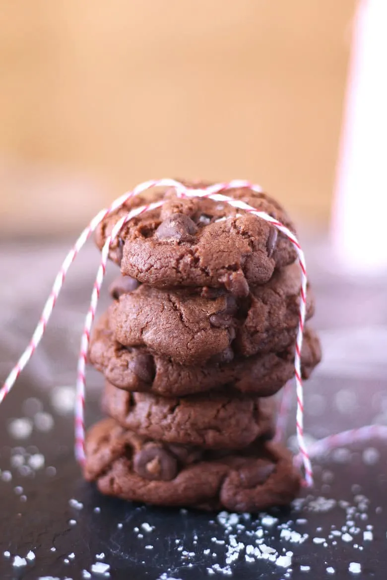 stack of double chocolate sea salt cookies tied with a string pin image