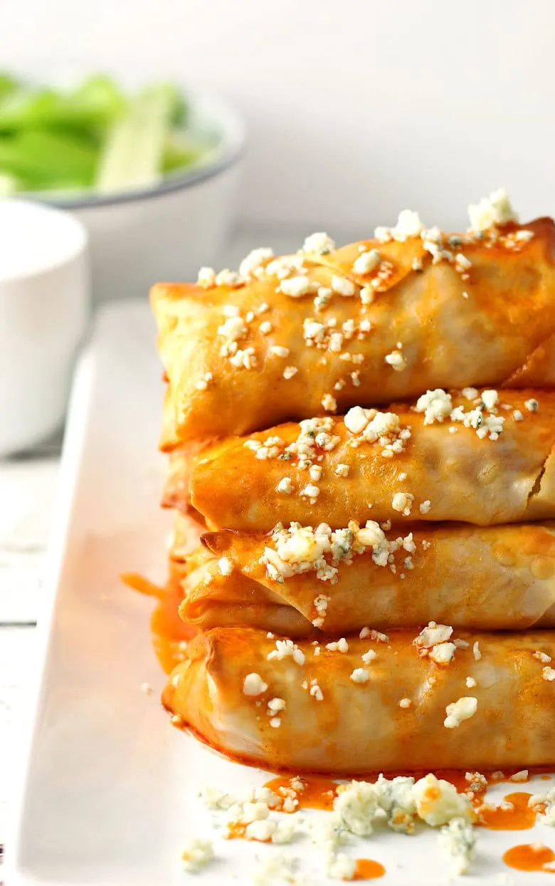 These baked buffalo chicken egg rolls are great as an appetizer or lunch! Pair them with blue cheese dressing and extra buffalo sauce! If you're looking for game day recipes, this is the perfect appetizer! | honeyandbirch.com
