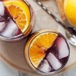 This orange red wine spritzer is a great cocktail for fall and winter. Mix up a batch of cinnamon simple syrup, grab a bottle of your favorite red and try this drink today! | honeyandbirch.com