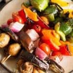 These rainbow veggie kabobs are the perfect summer side dish! Serve them with my delicious and easy to make grilled lemon garlic sauce.