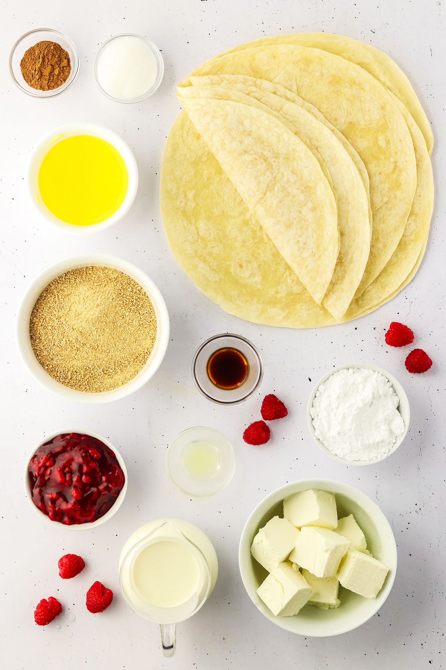 ingredients for raspberry cheesecake tacos on a white board