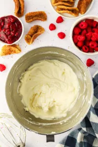 whisked cheesecake mixture in a stand mixer bowl